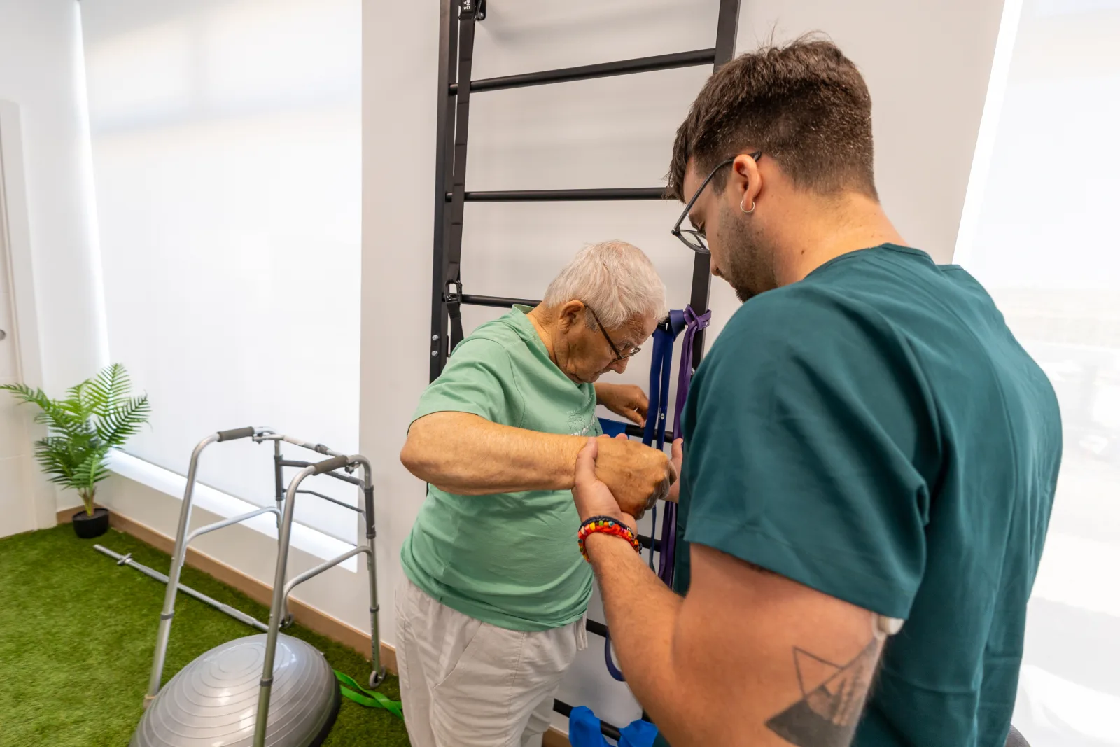 Fran González, fisioterapeuta neurológico de Clínica Apolo, trabajando la movilidad y la autonomía con un paciente durante su proceso de rehabilitación tras hab